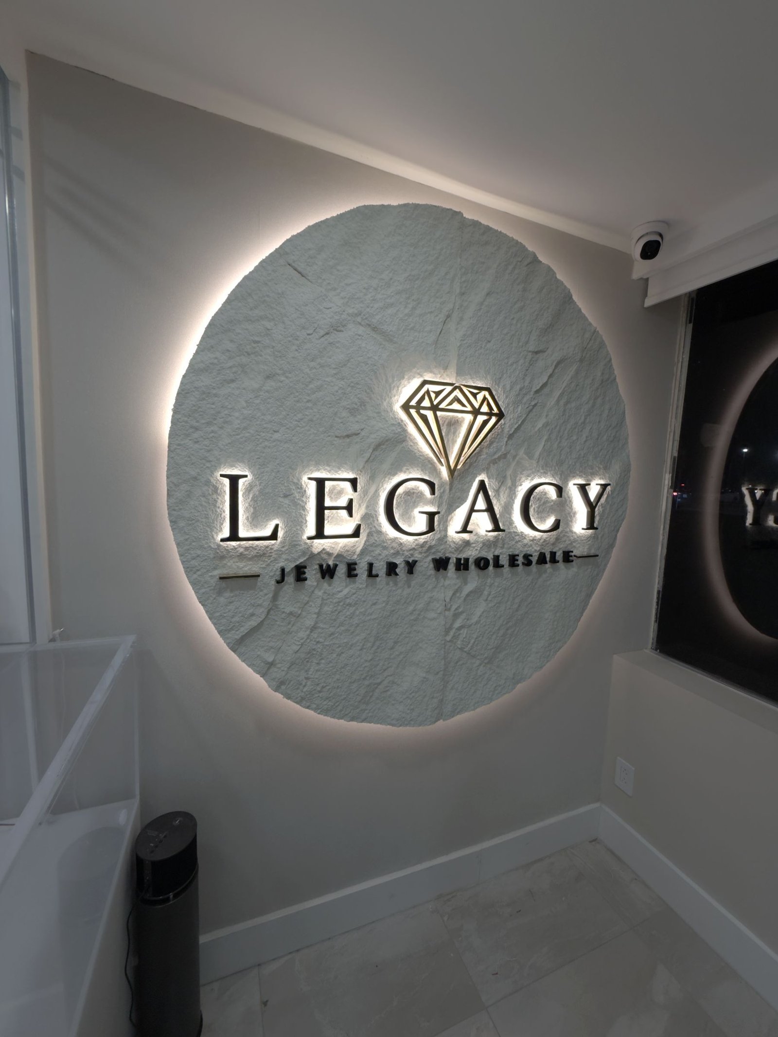 Round backlit sign with channel letters for a jewelry wholesaler, fabricated and installed by Synapse Sign