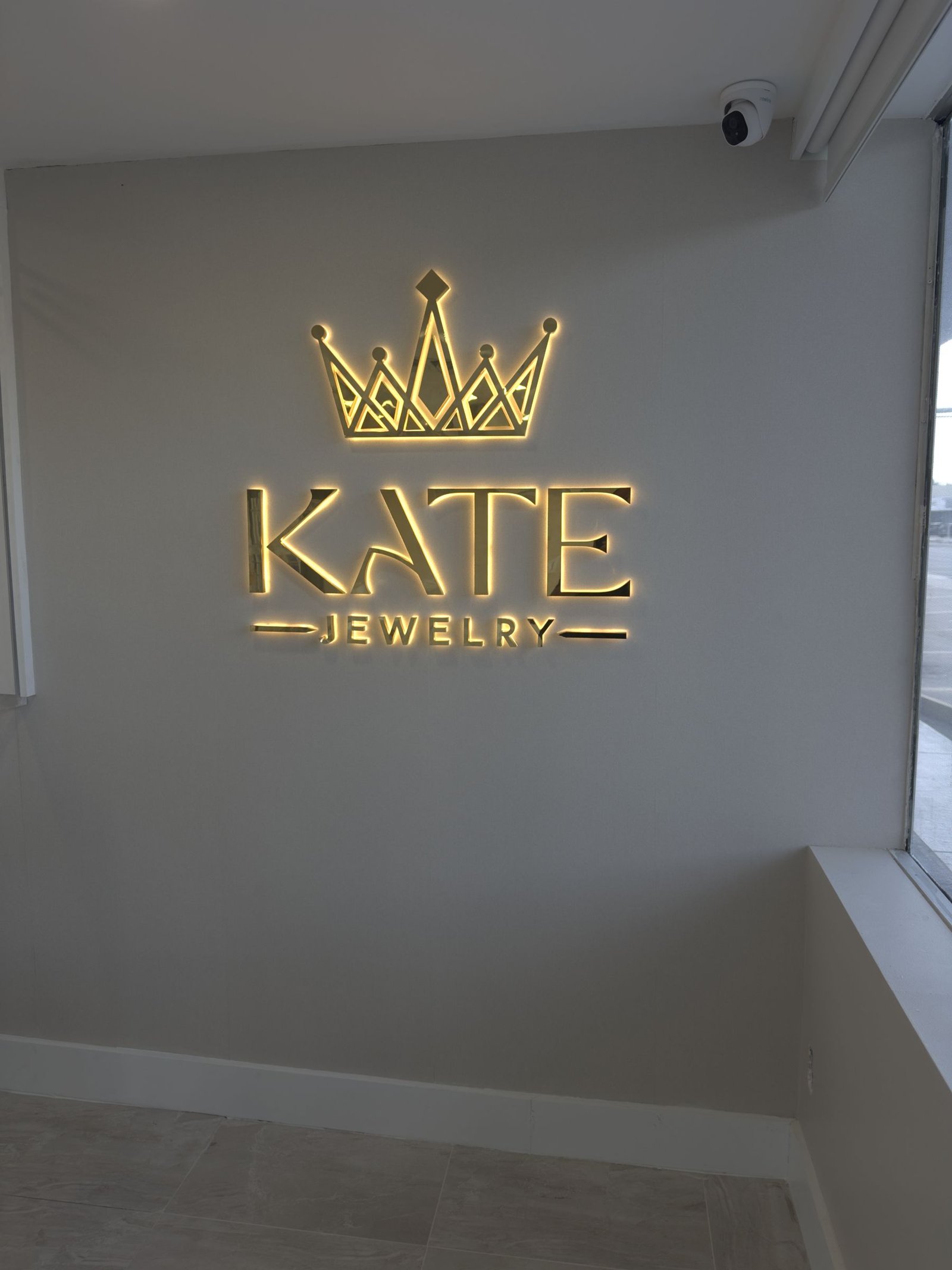 Illuminated gold letters and crown logo for Kate Jewelry