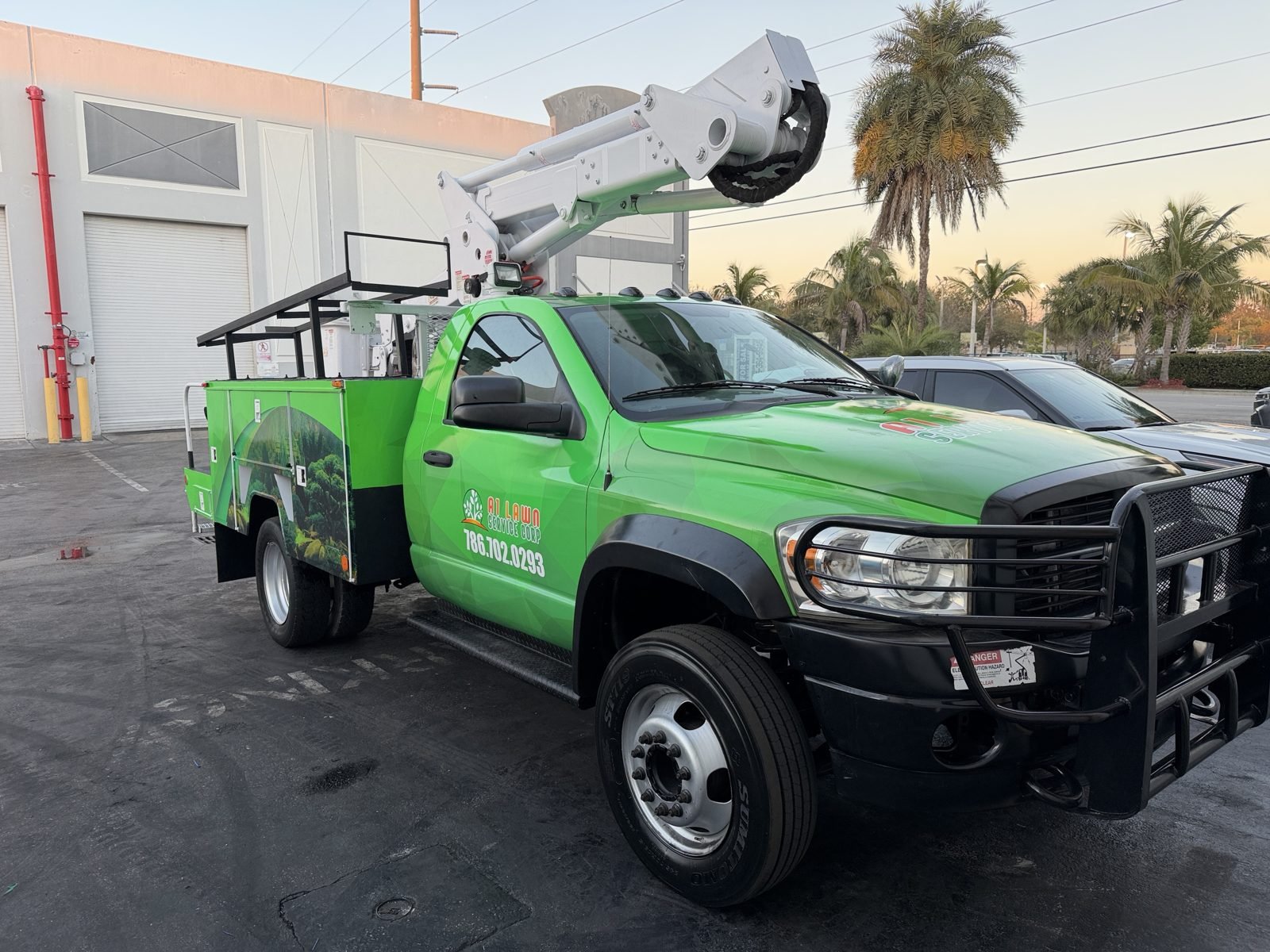Green bucket truck full wrap for A1 Lawn Service Corp, installed by Synapse Sign in Miami