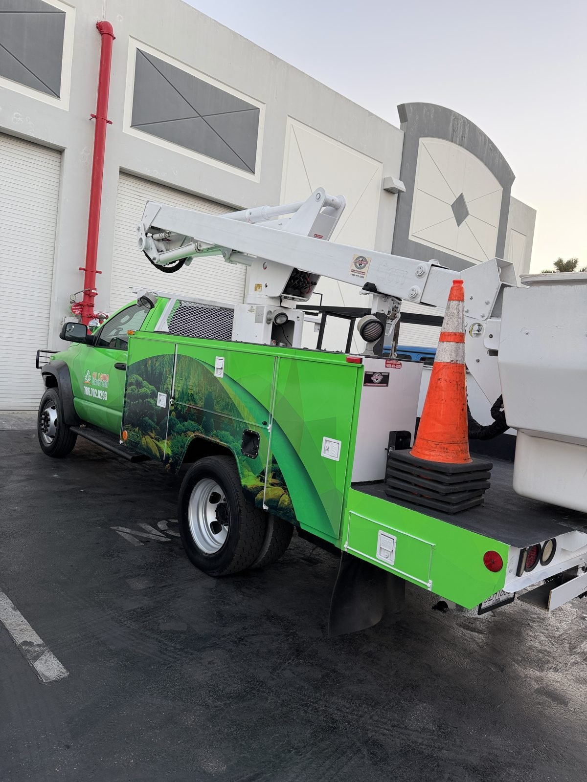 Utility truck body wrap with landscape graphics